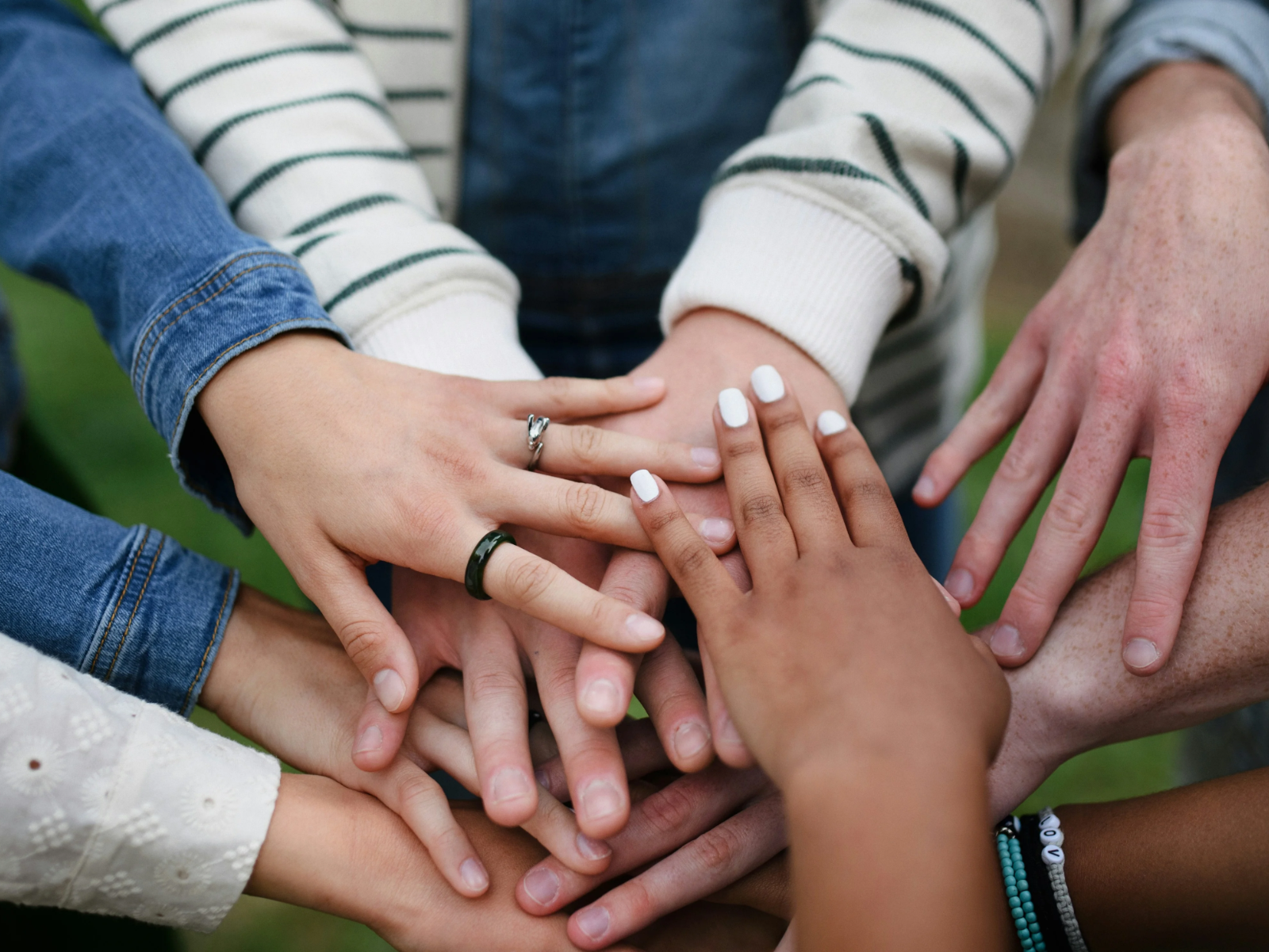 Hands of neighbors and partners stacked together