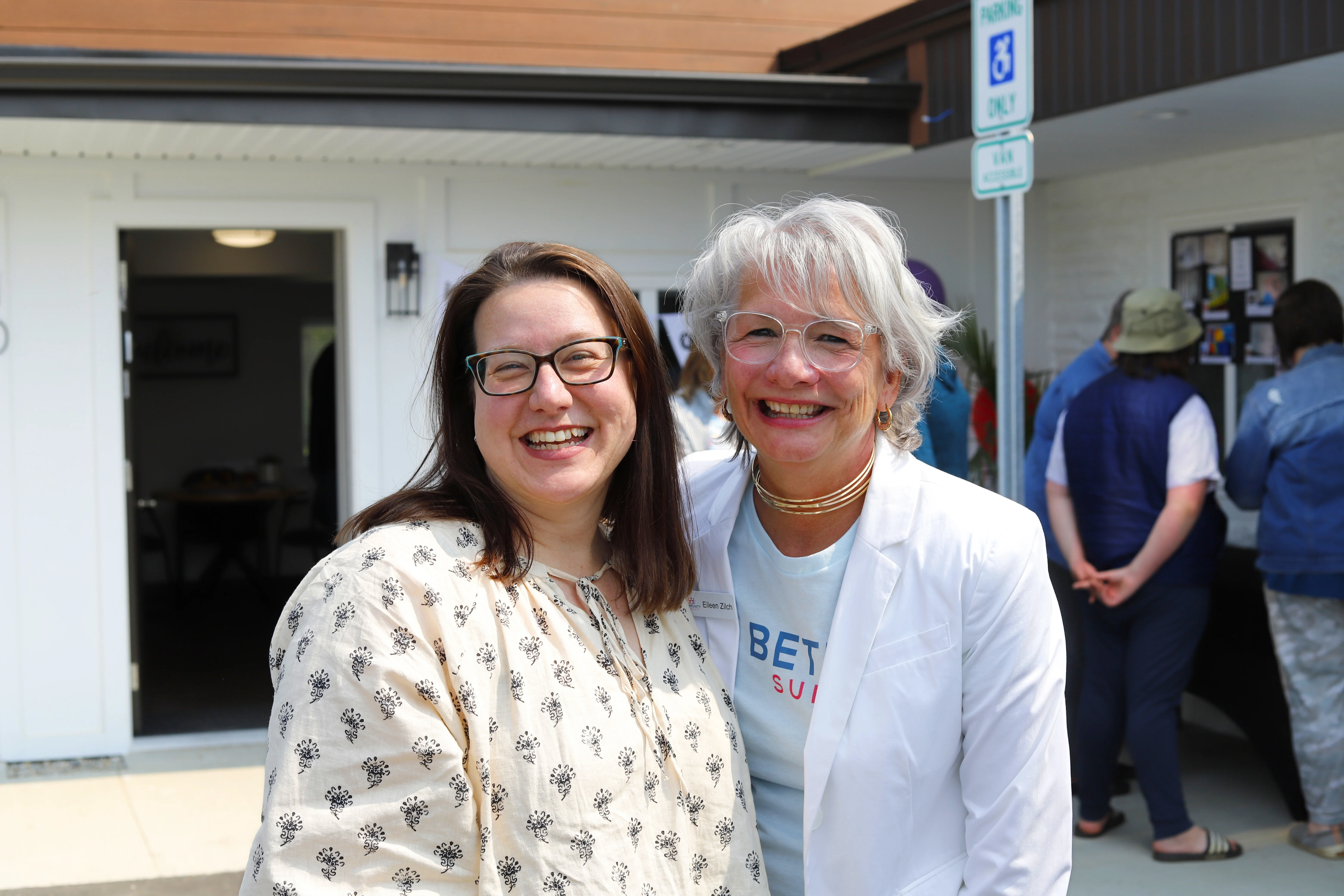 Two women smiling together at a Bethel Suites open house
