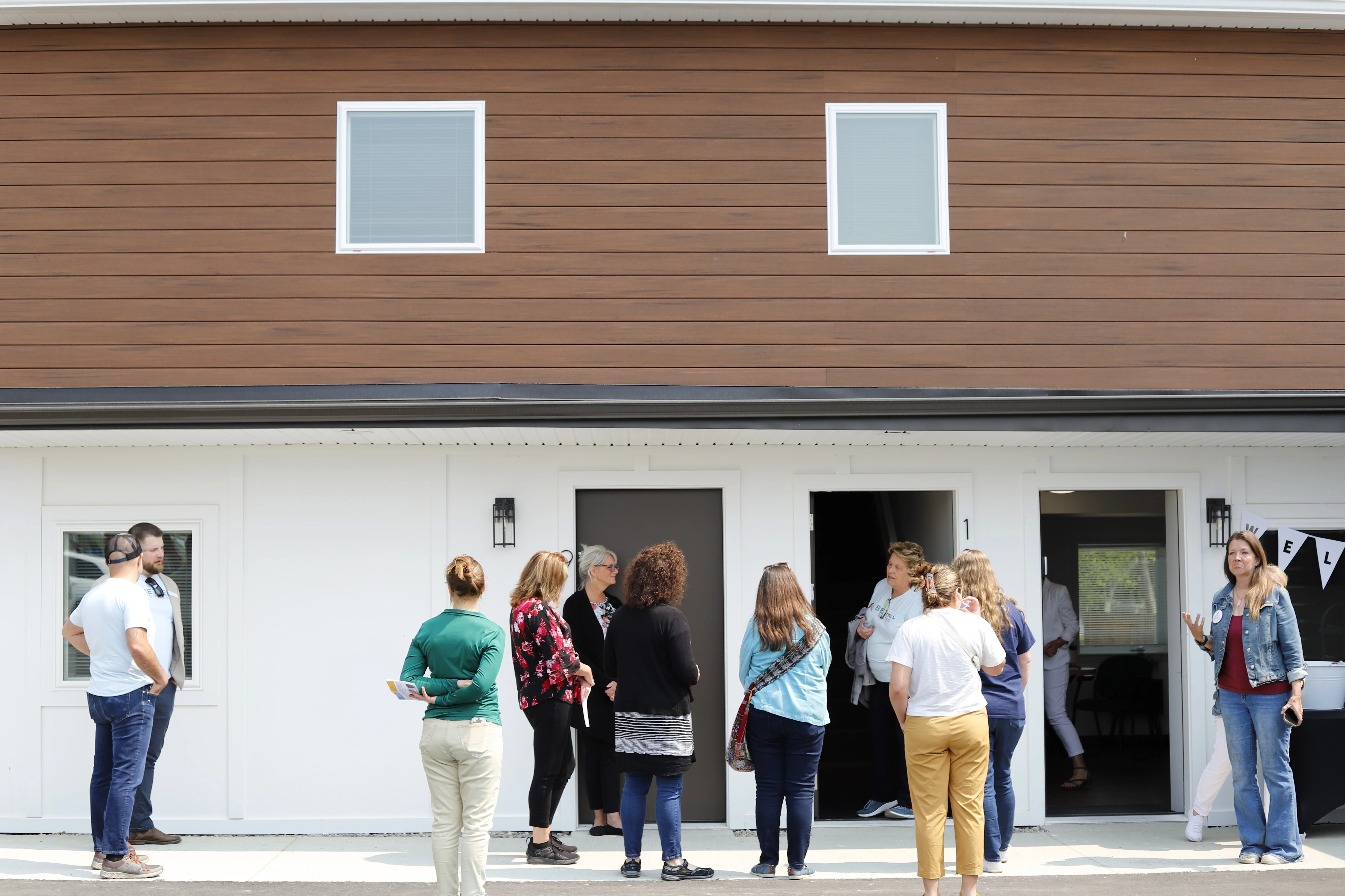 Neighbors tour the new units on Bethel Suites opening day
