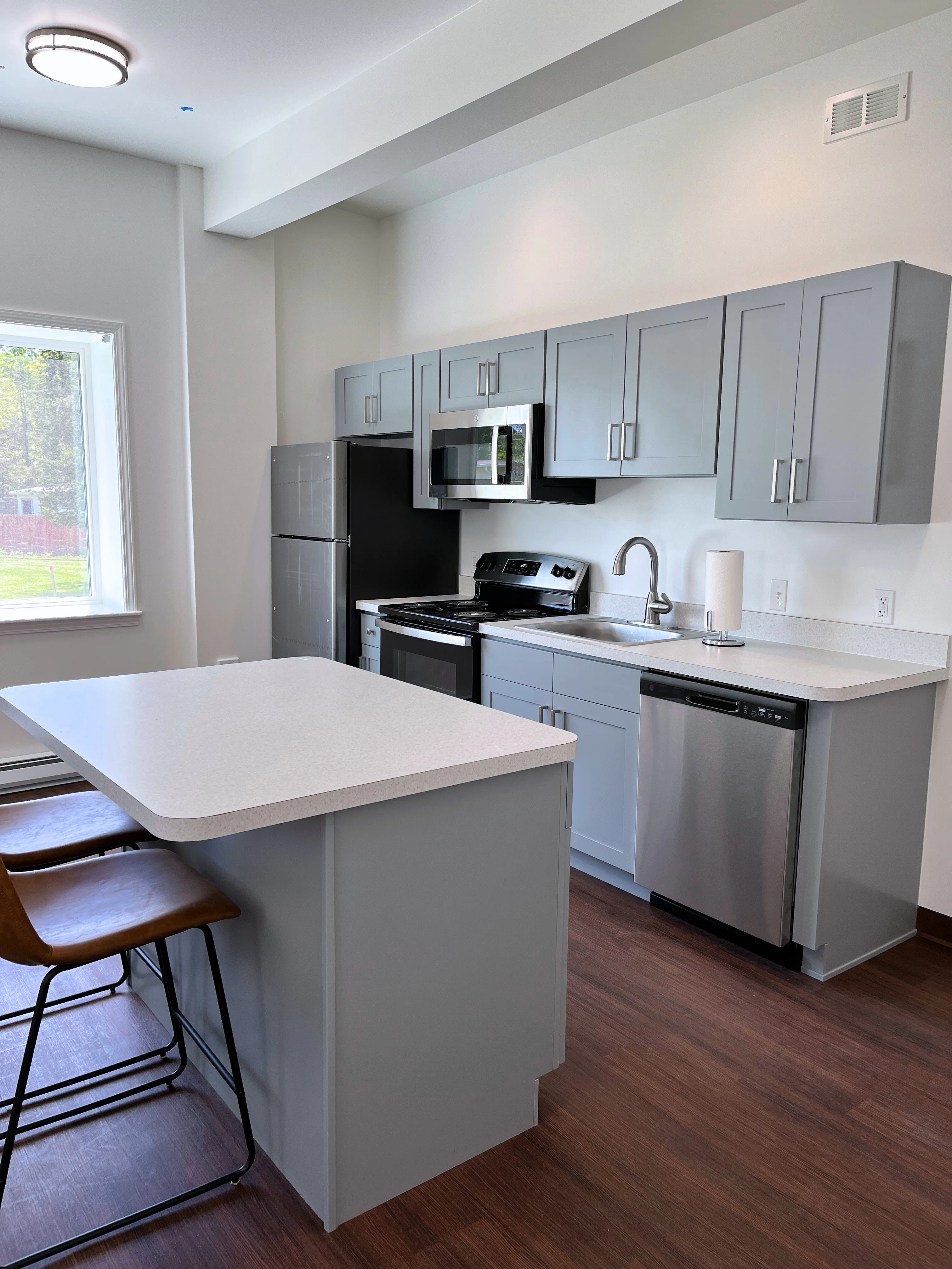 A furnished efficiency kitchen with an island