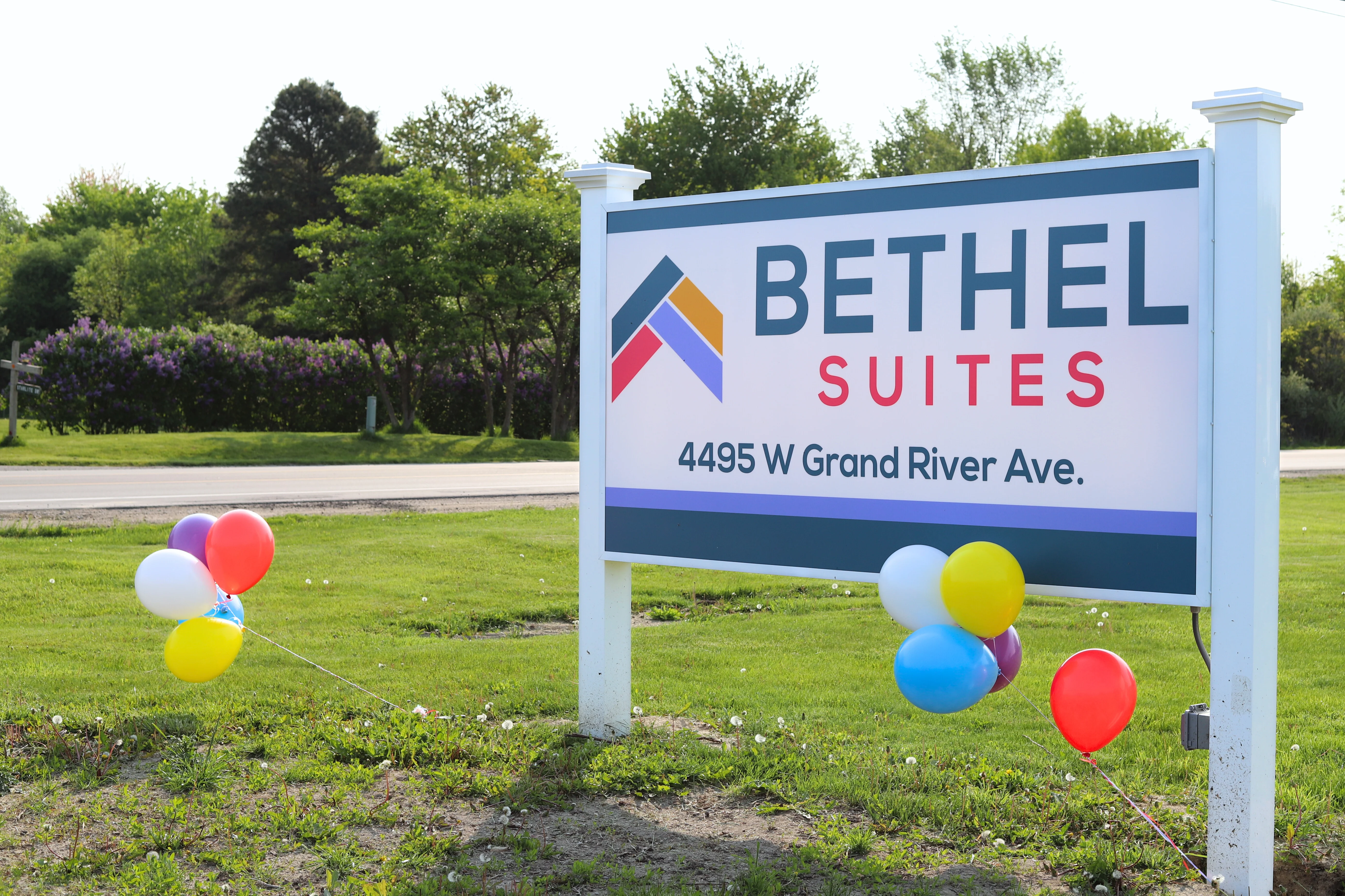 The Bethel Suites sign on Grand River Avenue, decorated for opening day