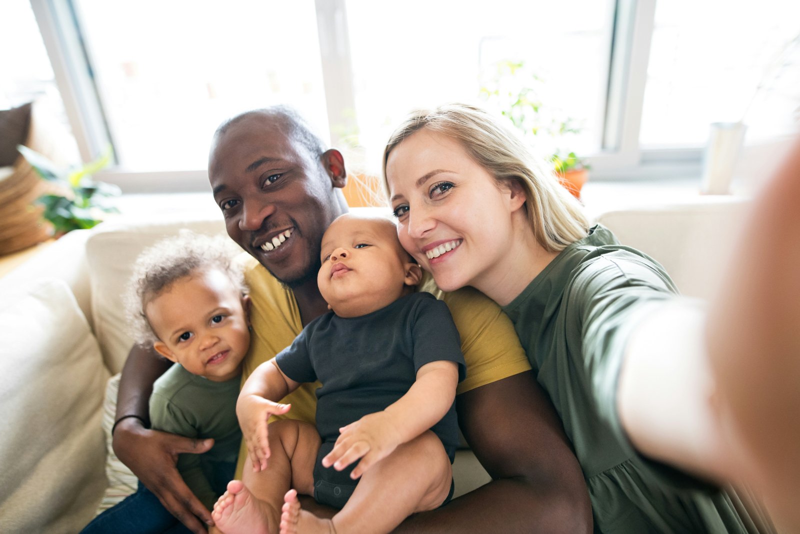 A young family taking a selfie together at home